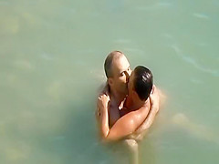 Nudist couple enjoying the fresh water