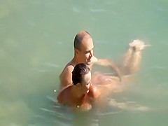 Nudist couple enjoying the fresh water