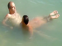 Nudist couple enjoying the fresh water