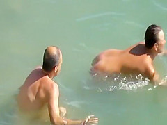 Nudist couple enjoying the fresh water