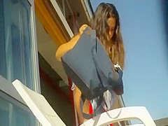 Curly sexy girl checked out next to a pool