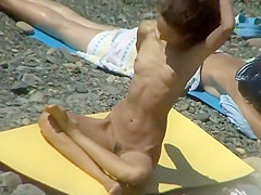 Nudist girl does yoga on the beach