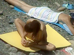 Nudist girl does yoga on the beach