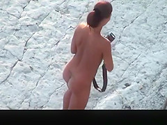 Nude woman with pierced belly and tattoo