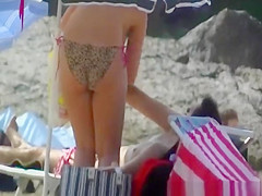 Busty woman topless in beach