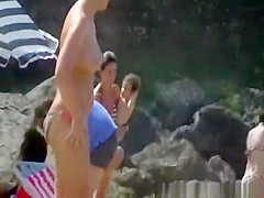Busty woman topless in beach