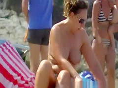 Busty woman topless in beach