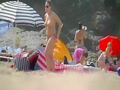 Busty woman topless in beach