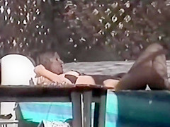 Spy a hot woman with a dildo by the pool