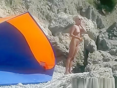 Blonde nudist woman secretly filmed at beach