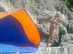 Blonde nudist woman secretly filmed at beach