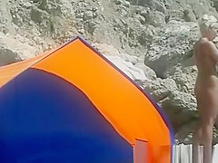 Blonde nudist woman secretly filmed at beach