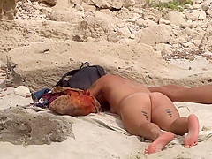 Hot tattooed girl sunbathes nude