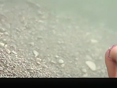 Topless chick with small boobs in the water