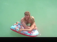 Topless chick with small boobs in the water