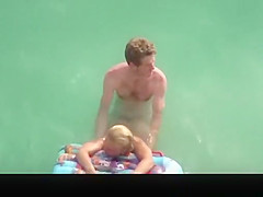 Topless chick with small boobs in the water