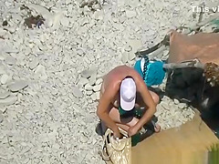 Nudist woman spied in beach sunbathing