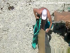 Nudist woman spied in beach sunbathing