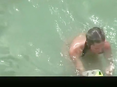 Nude couple refreshing in the wate
