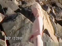 Small tits nudist at rocky beach