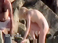 Small tits nudist at rocky beach