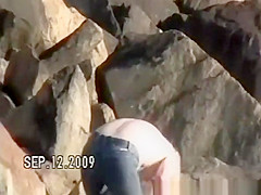 Small tits nudist at rocky beach