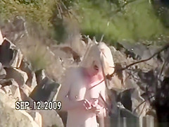 Small tits nudist at rocky beach