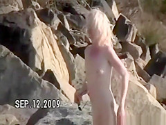 Small tits nudist at rocky beach