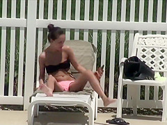 Voyeur spies a girl by the swimming pool