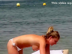 Topless girls relaxing by the beach