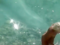 Drunk slut strips her bikini in the water