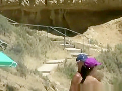 Nudist woman reading and eating