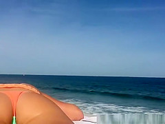 Teen in bikini sunbathing in the concrete