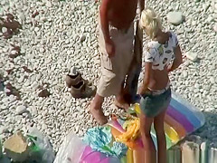 Couple undressing in beach