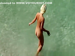 Couple undressing in beach