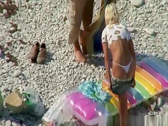 Couple undressing in beach