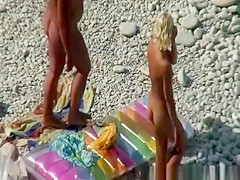 Couple undressing in beach