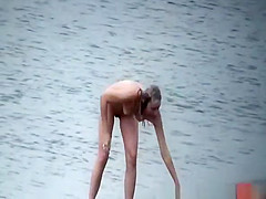 Nudist washes head in beach
