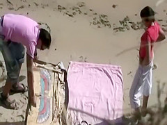 He caresses her butt while she sucks him