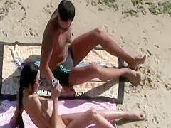 He caresses her butt while she sucks him