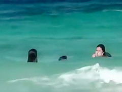 Topless girls running in the water