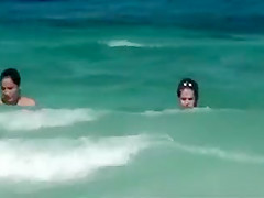 Topless girls running in the water