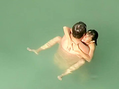 Spying two teenagers fuck in the water