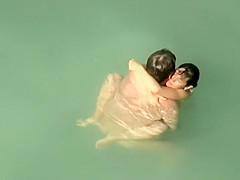 Spying two teenagers fuck in the water