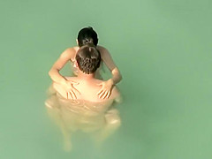 Spying two teenagers fuck in the water
