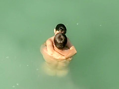 Spying two teenagers fuck in the water