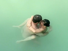 Spying two teenagers fuck in the water