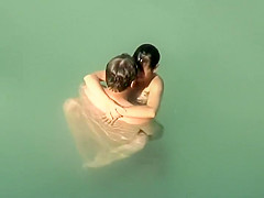 Spying two teenagers fuck in the water