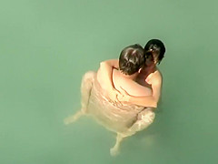 Spying two teenagers fuck in the water