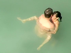 Spying two teenagers fuck in the water